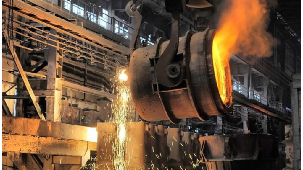 "Válvulas metalúrgicas de fundición en taller industrial con el fondo de las torres de perforación de Vaca Muerta."